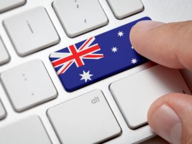 Finger pushing on computer keyboard with Australian flag symbol