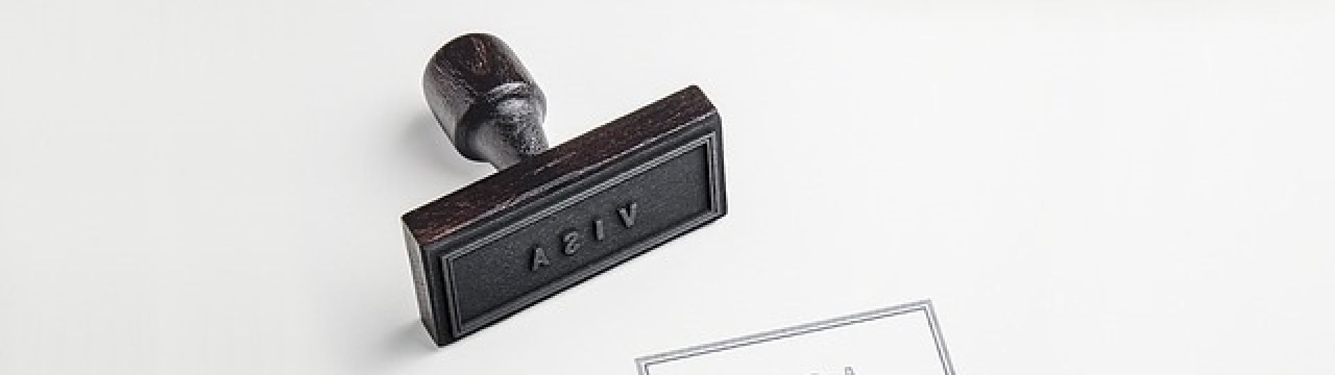 A black stamp that says 'visa' with the same symbol stamped on a piece of paper
