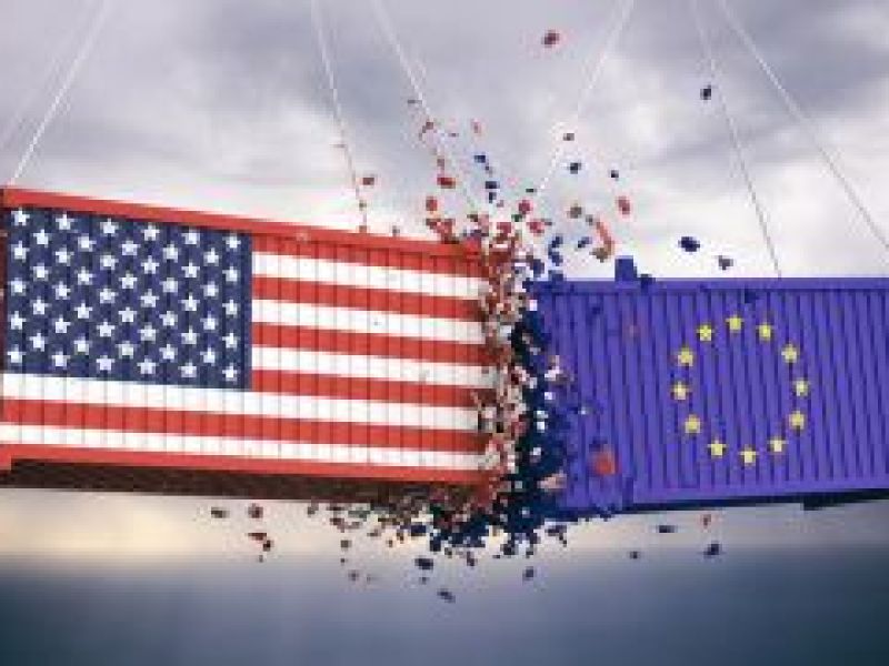 Two shipping containers - one with a US flag, one with an EU flag - smash together mid-air