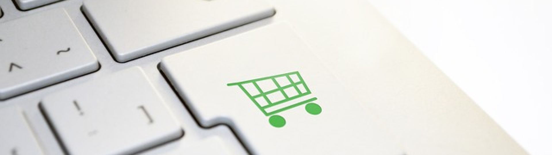 A computer keyboard with a picture of a shopping trolley on the enter button, representing online shopping