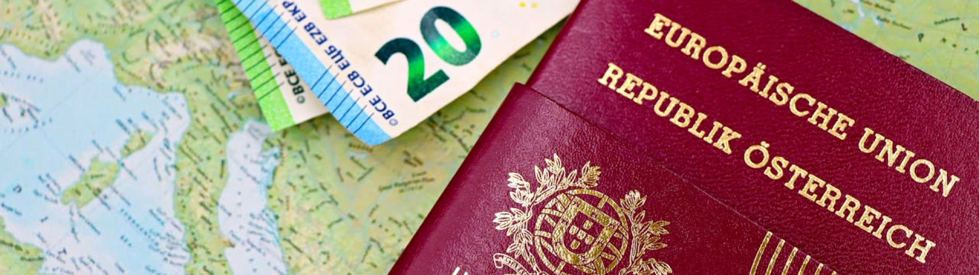 A passport on top of a map with several euro banknotes