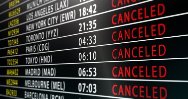Airport departure board showing international flights cancelled
