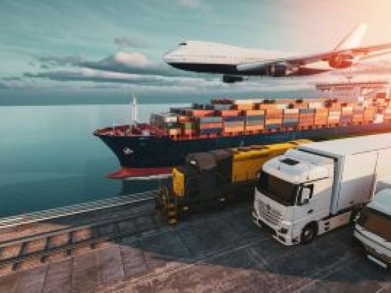 Plane, container ship and two lorries travelling left