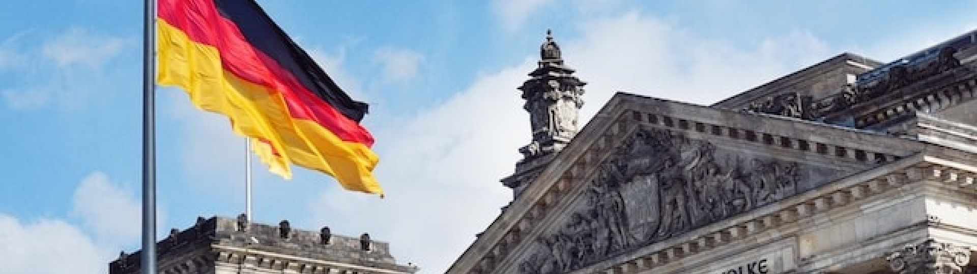The German flag flying outside of the Reichstag in Berlin