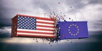 Two shipping containers - one with a US flag, one with an EU flag - smash together mid-air